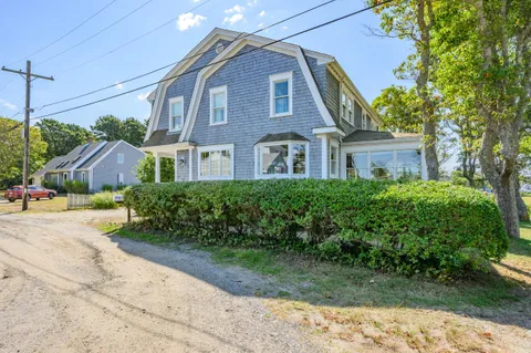 a front view of a house with a garden