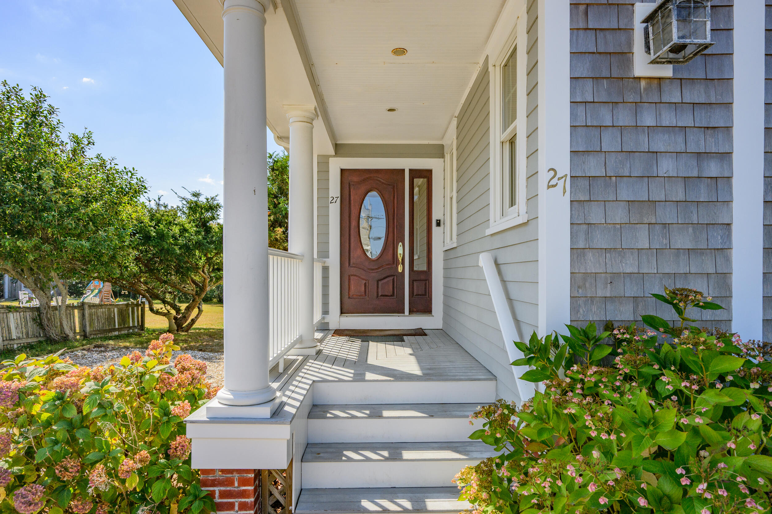 27 Mayflower Lane Dennis Port, MA 02639 - Photo 20 of 35 a front view of a house with a garden