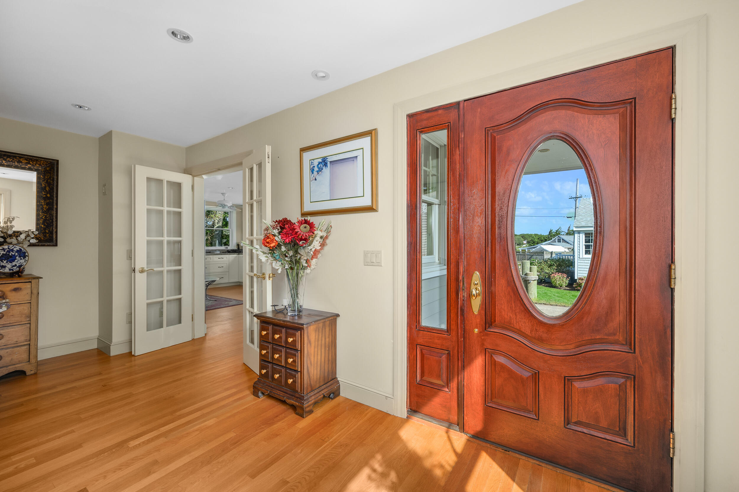 27 Mayflower Lane Dennis Port, MA 02639 - Photo 22 of 35 a living room with furniture a chandelier and a wooden floor