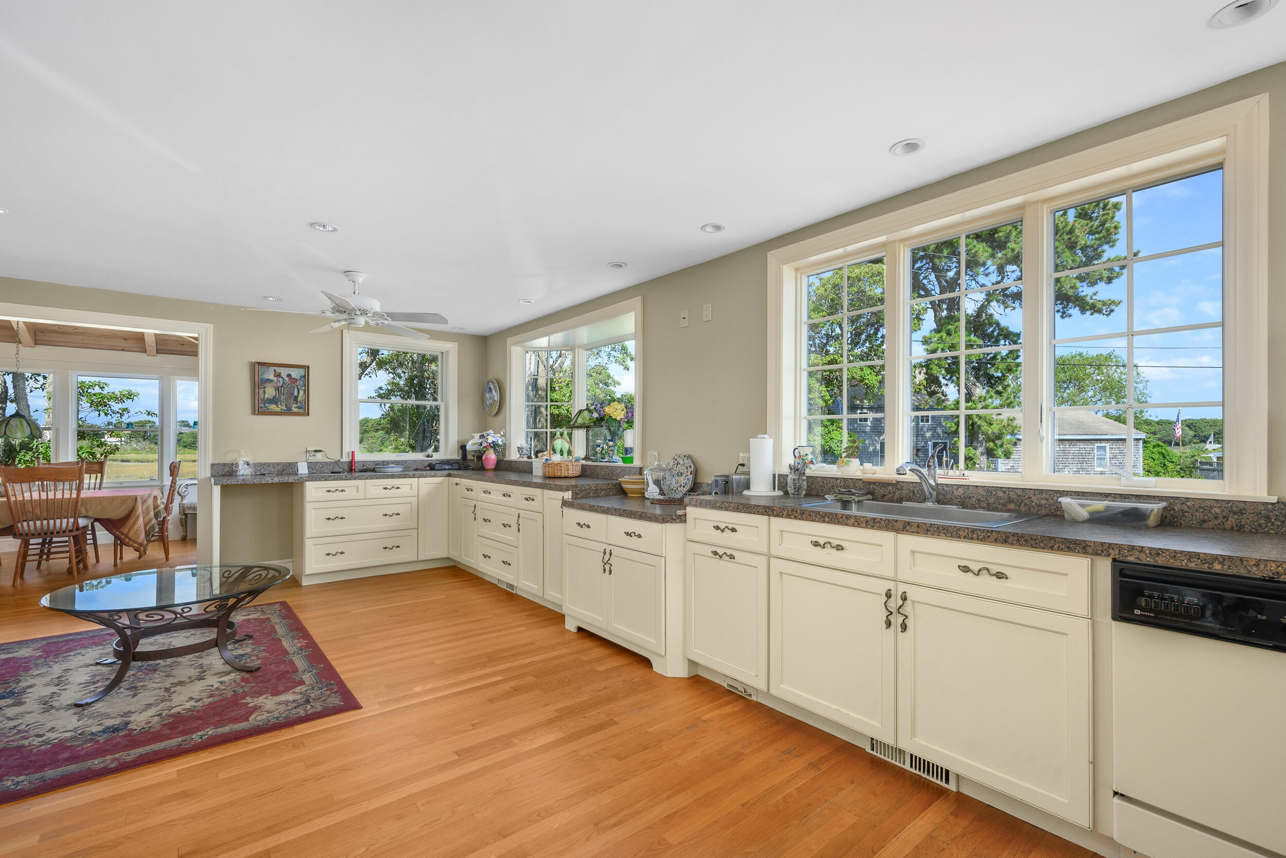 27 Mayflower Lane Dennis Port, MA 02639 - Photo 23 of 35 a large white kitchen with granite countertop a stove a sink and white cabinets