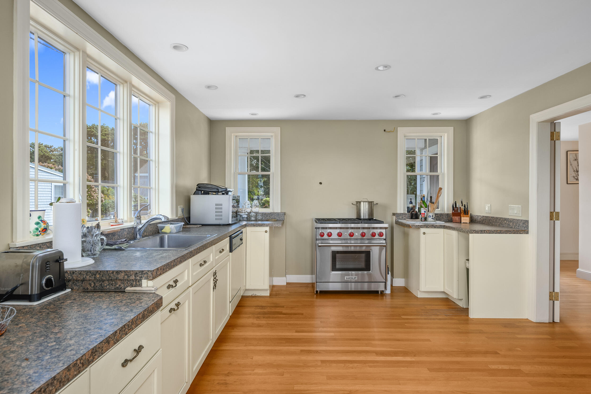 27 Mayflower Lane Dennis Port, MA 02639 - Photo 25 of 35 a large kitchen with a sink and cabinets