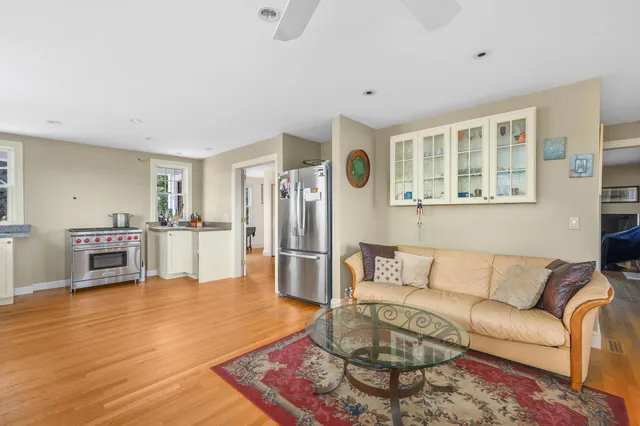 a living room with furniture and kitchen view