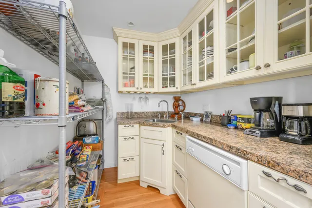 a kitchen with stainless steel appliances granite countertop a sink and cabinets