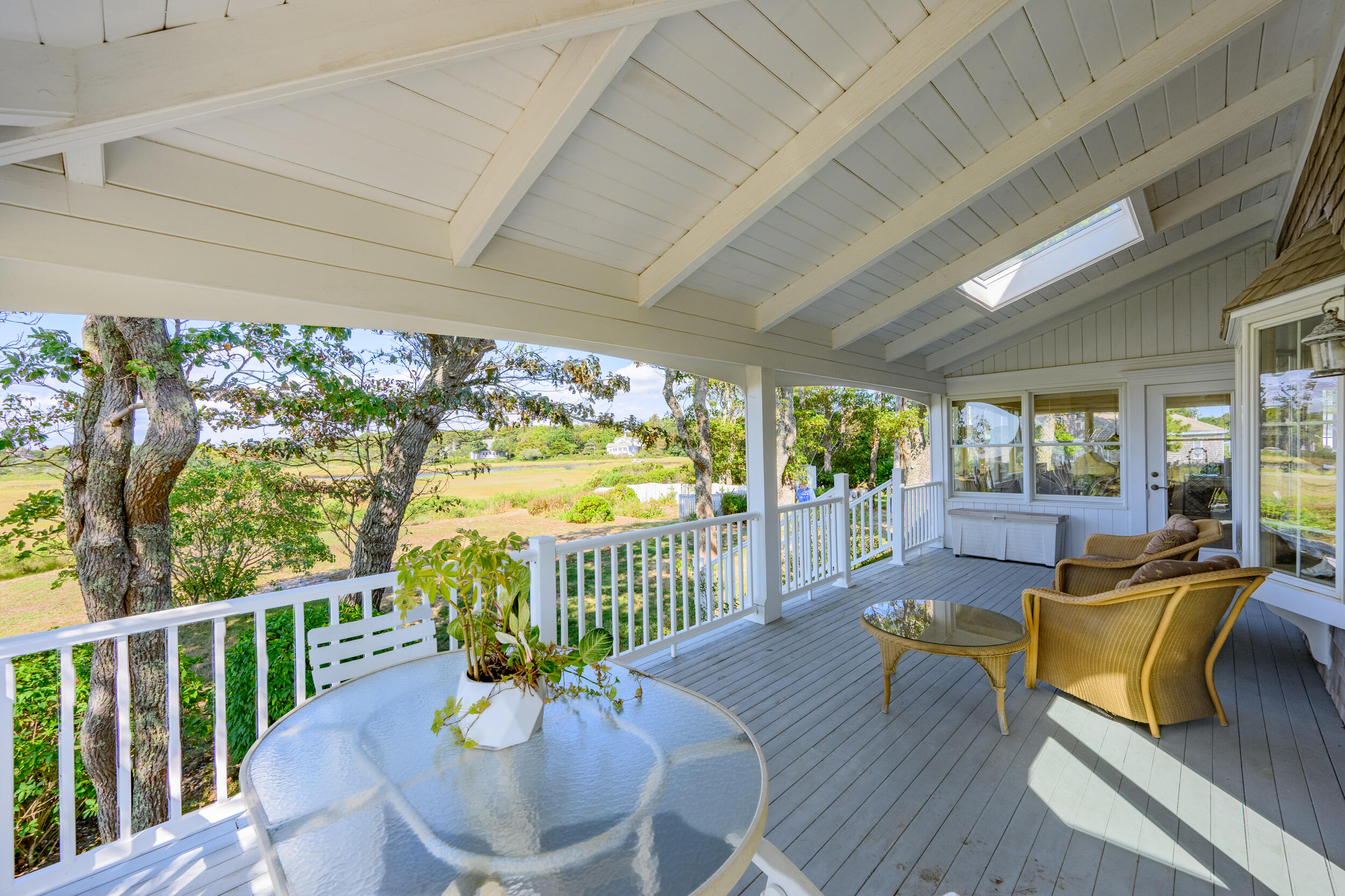 27 Mayflower Lane Dennis Port, MA 02639 - Photo 5 of 35 a view of a patio with couches chairs potted plants and wooden floor