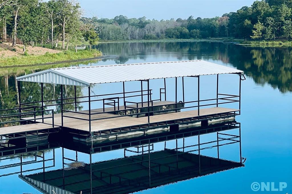 a view of a lake with a bench and a table