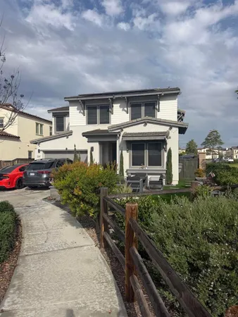 an aerial view of a house with balcony and car parked