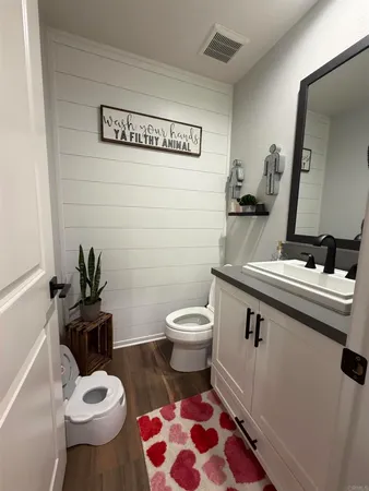 a bathroom with a sink a toilet and a mirror