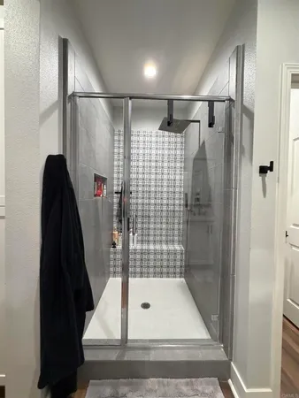 a bathroom with a shower and a tub