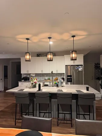 a kitchen with a dining table chairs and view living room