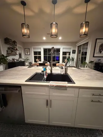 a kitchen with stainless steel appliances granite countertop a sink and a stove
