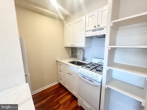 a kitchen with cabinets and a stove