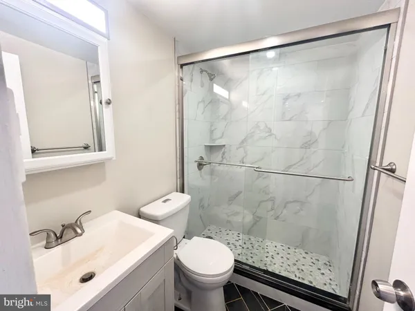 a bathroom with a sink toilet and shower
