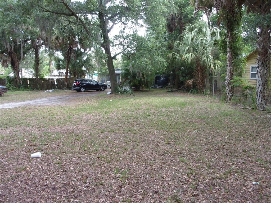 a view of a yard with car parked