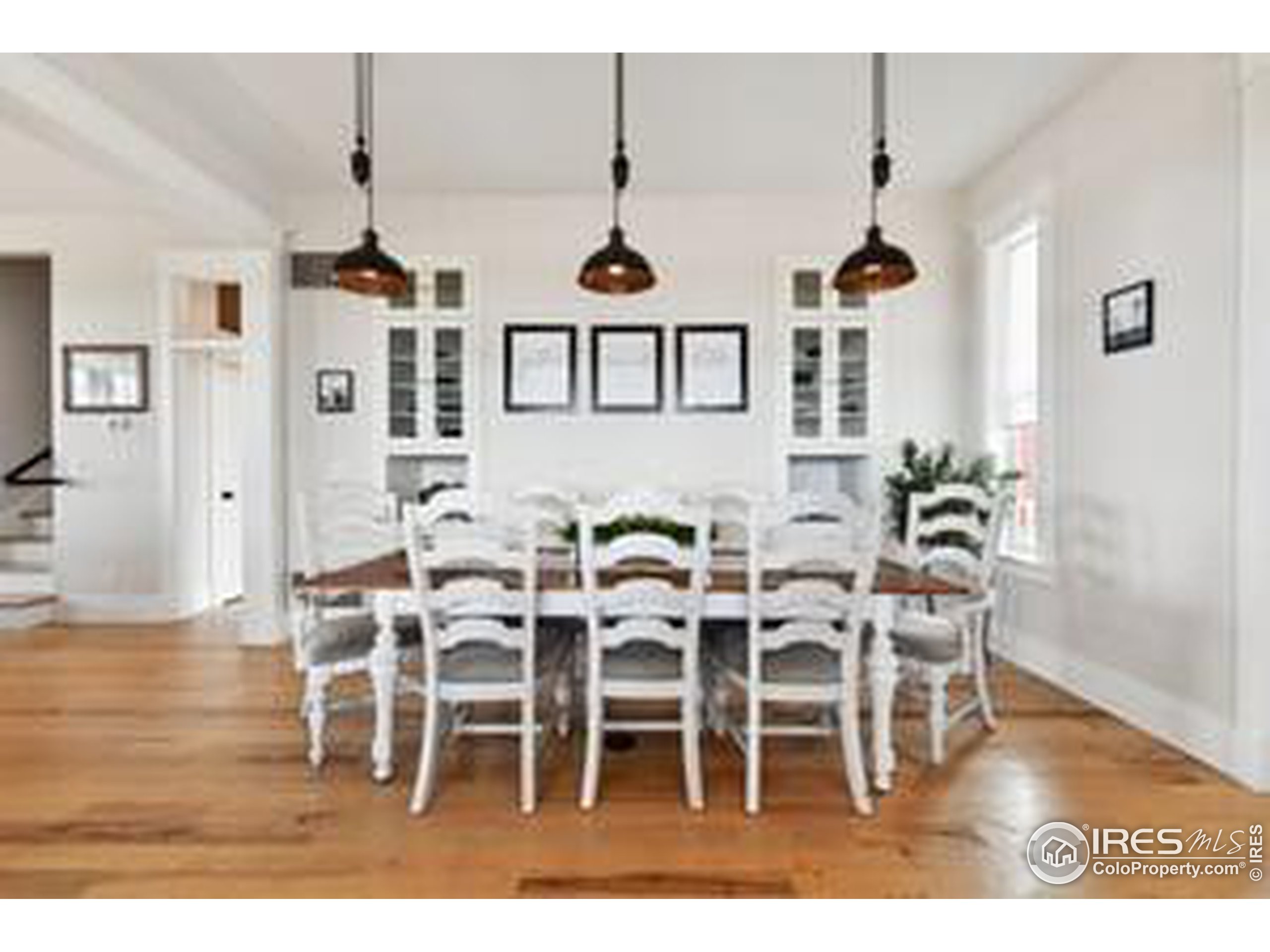 6261 County Road 41 Fort Lupton, CO 80621 - Photo 13 of 40 a dining room with furniture wooden floor a rug and a chandelier
