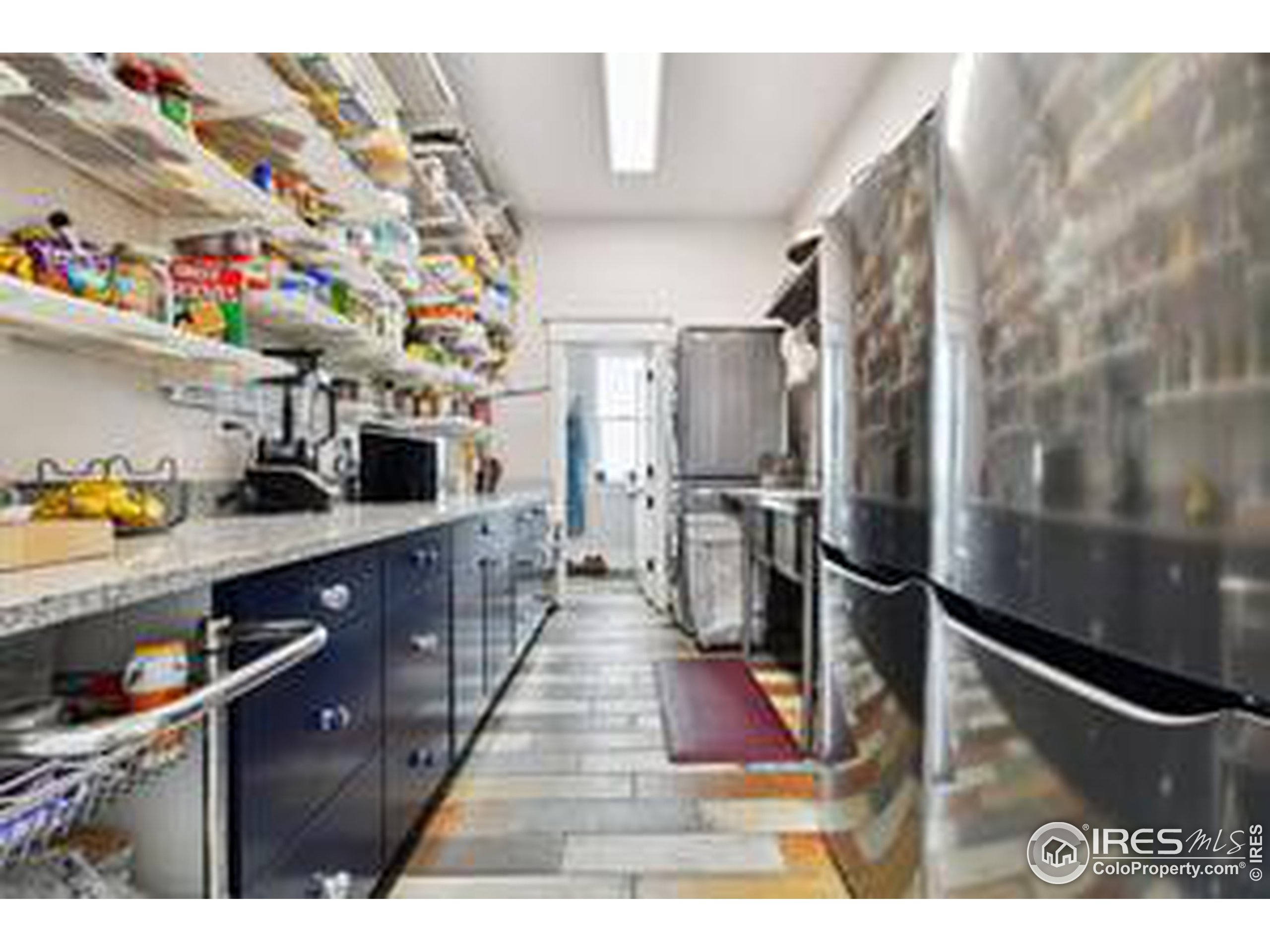6261 County Road 41 Fort Lupton, CO 80621 - Photo 14 of 40 a kitchen with stainless steel appliances granite countertop a refrigerator a sink and wooden cabinets