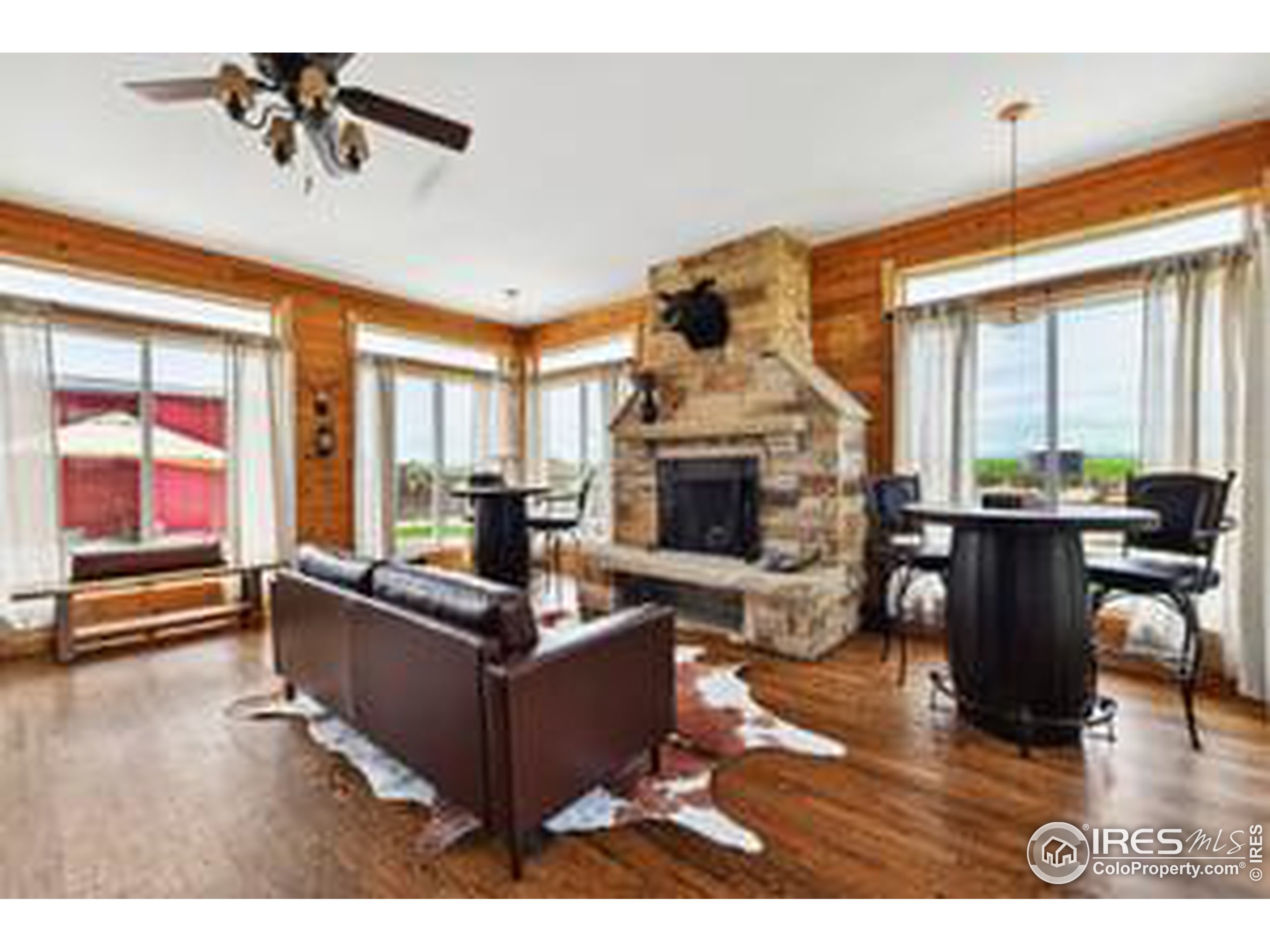 6261 County Road 41 Fort Lupton, CO 80621 - Photo 17 of 40 a living room with furniture a fireplace and a flat screen tv