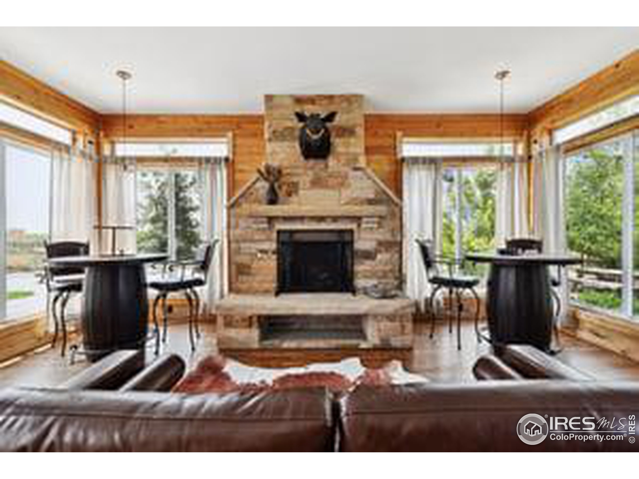 6261 County Road 41 Fort Lupton, CO 80621 - Photo 18 of 40 a living room with furniture a flat screen tv and a fireplace