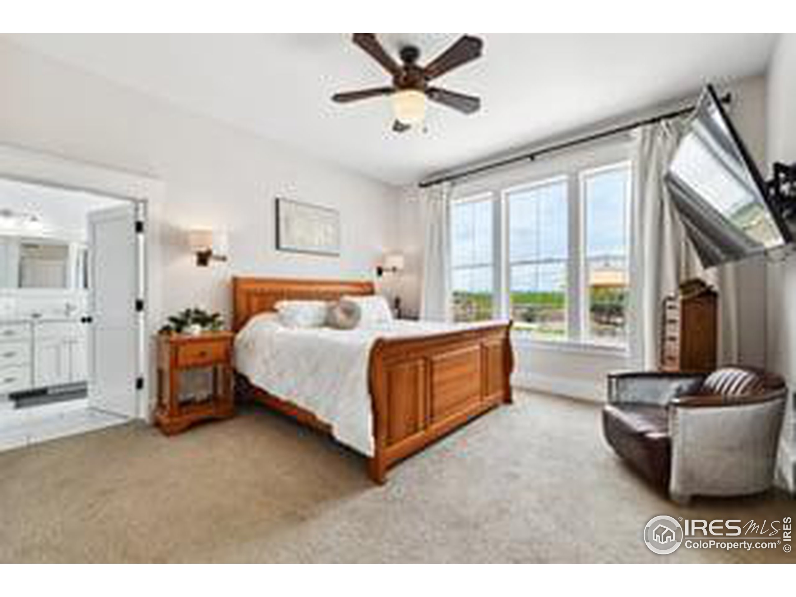 6261 County Road 41 Fort Lupton, CO 80621 - Photo 20 of 40 a spacious bedroom with a bed and a large window