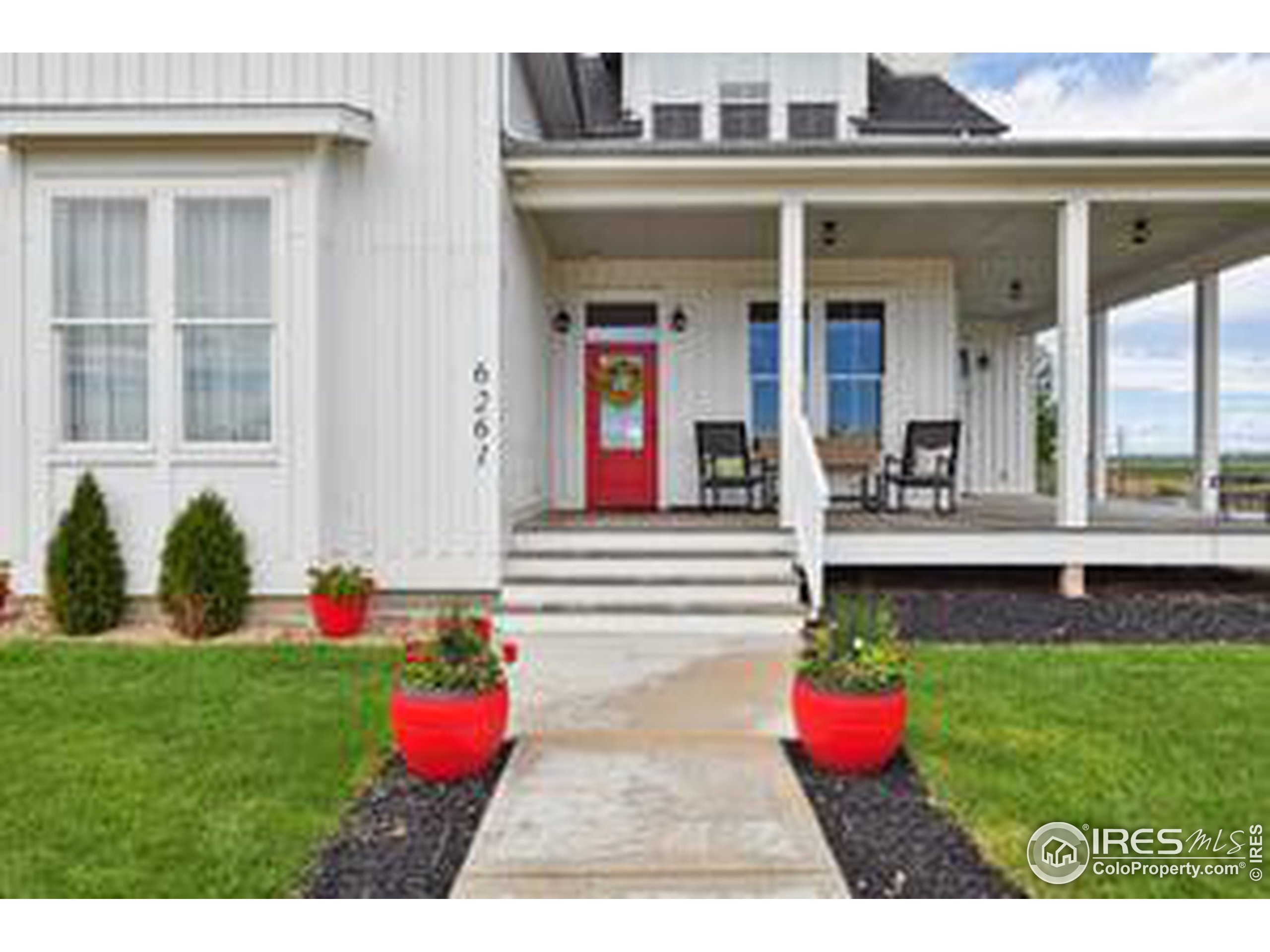 6261 County Road 41 Fort Lupton, CO 80621 - Photo 2 of 40 a view of a house with a yard potted plants and a table chair