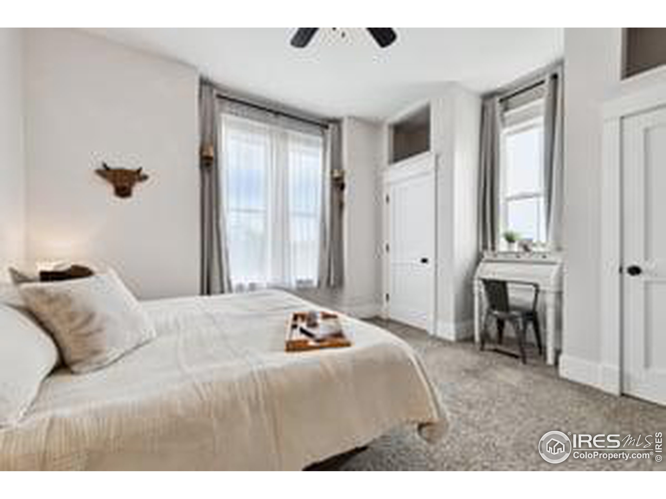 6261 County Road 41 Fort Lupton, CO 80621 - Photo 23 of 40 a bedroom with a bed and a chandelier