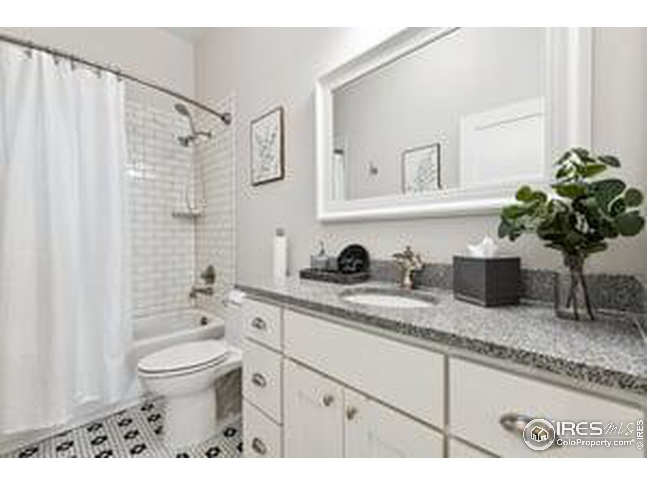 6261 County Road 41 Fort Lupton, CO 80621 - Photo 24 of 40 a bathroom with a granite countertop sink a toilet and mirror