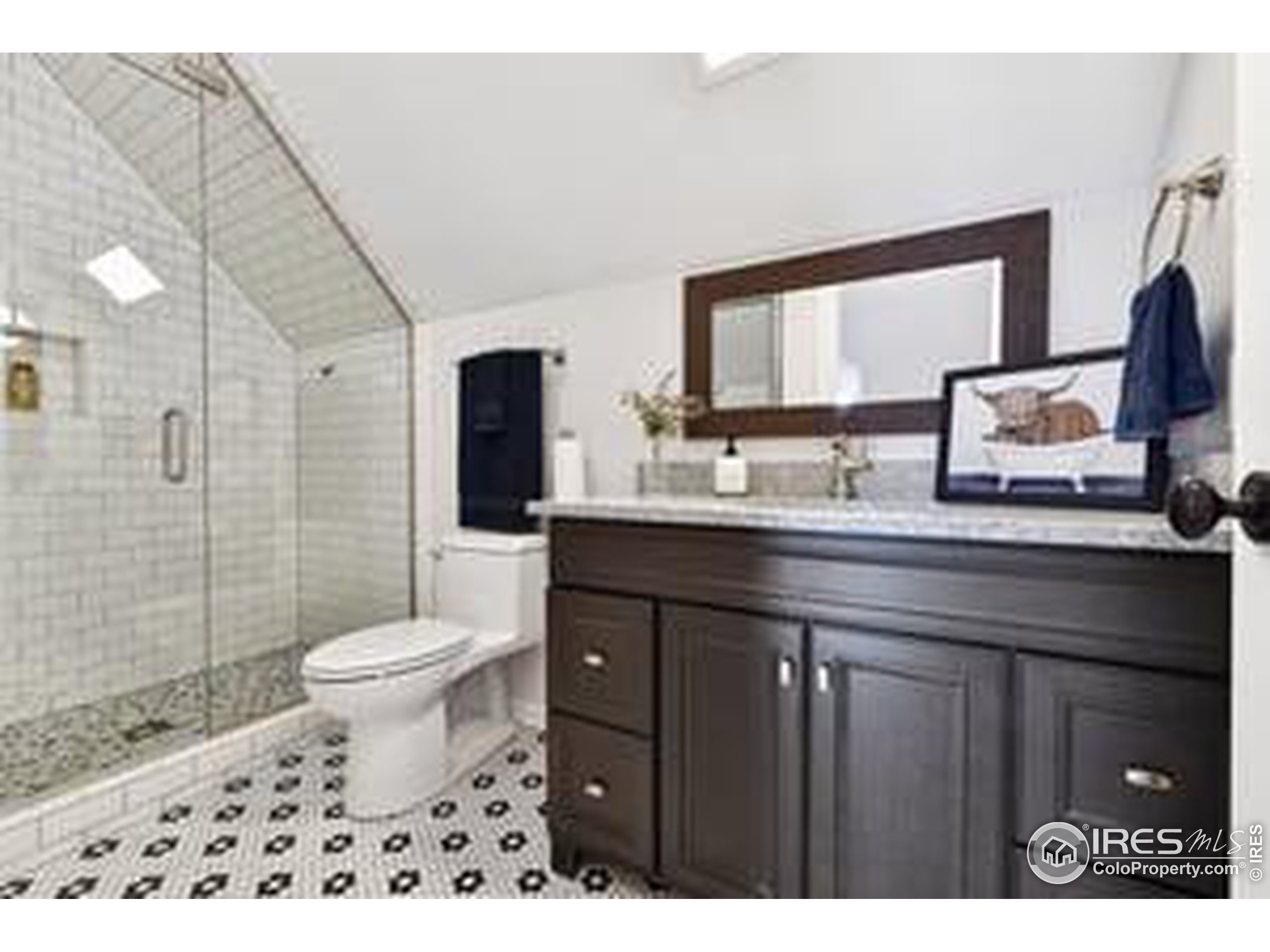 6261 County Road 41 Fort Lupton, CO 80621 - Photo 27 of 40 a bathroom with a sink toilet a mirror and shower