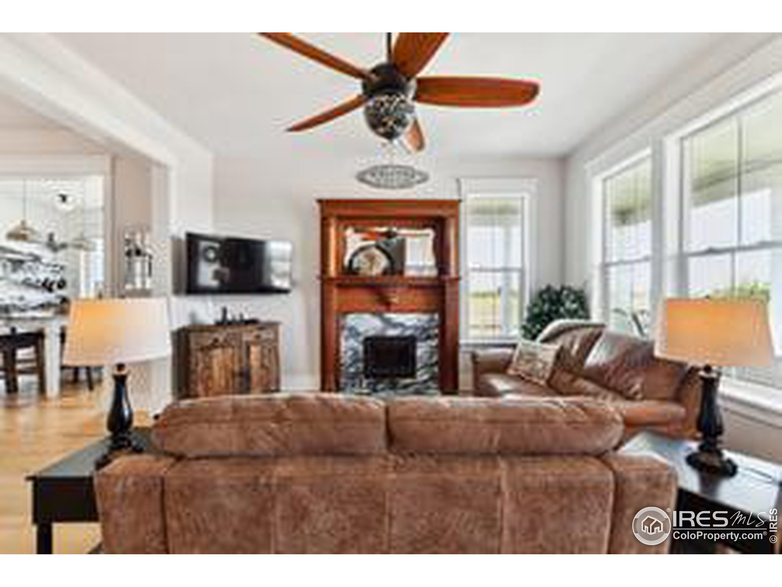 6261 County Road 41 Fort Lupton, CO 80621 - Photo 6 of 40 a living room with furniture a fireplace and a flat screen tv