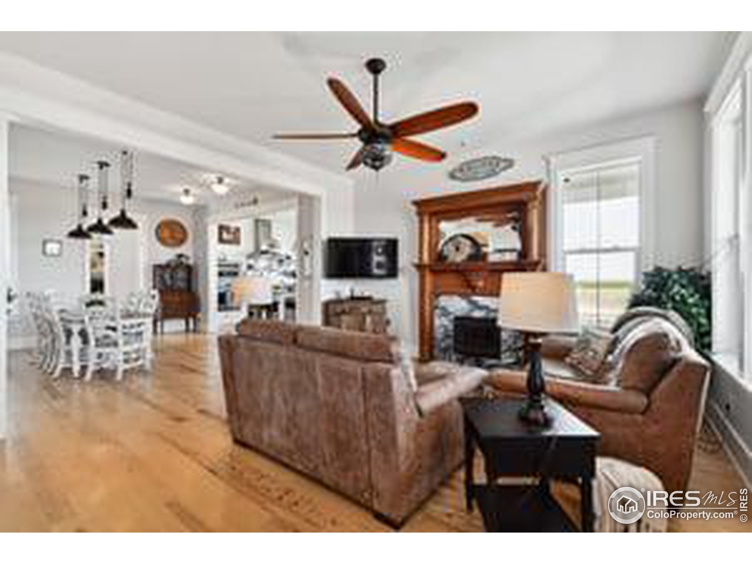 6261 County Road 41 Fort Lupton, CO 80621 - Photo 7 of 40 a living room with furniture a fireplace and a window