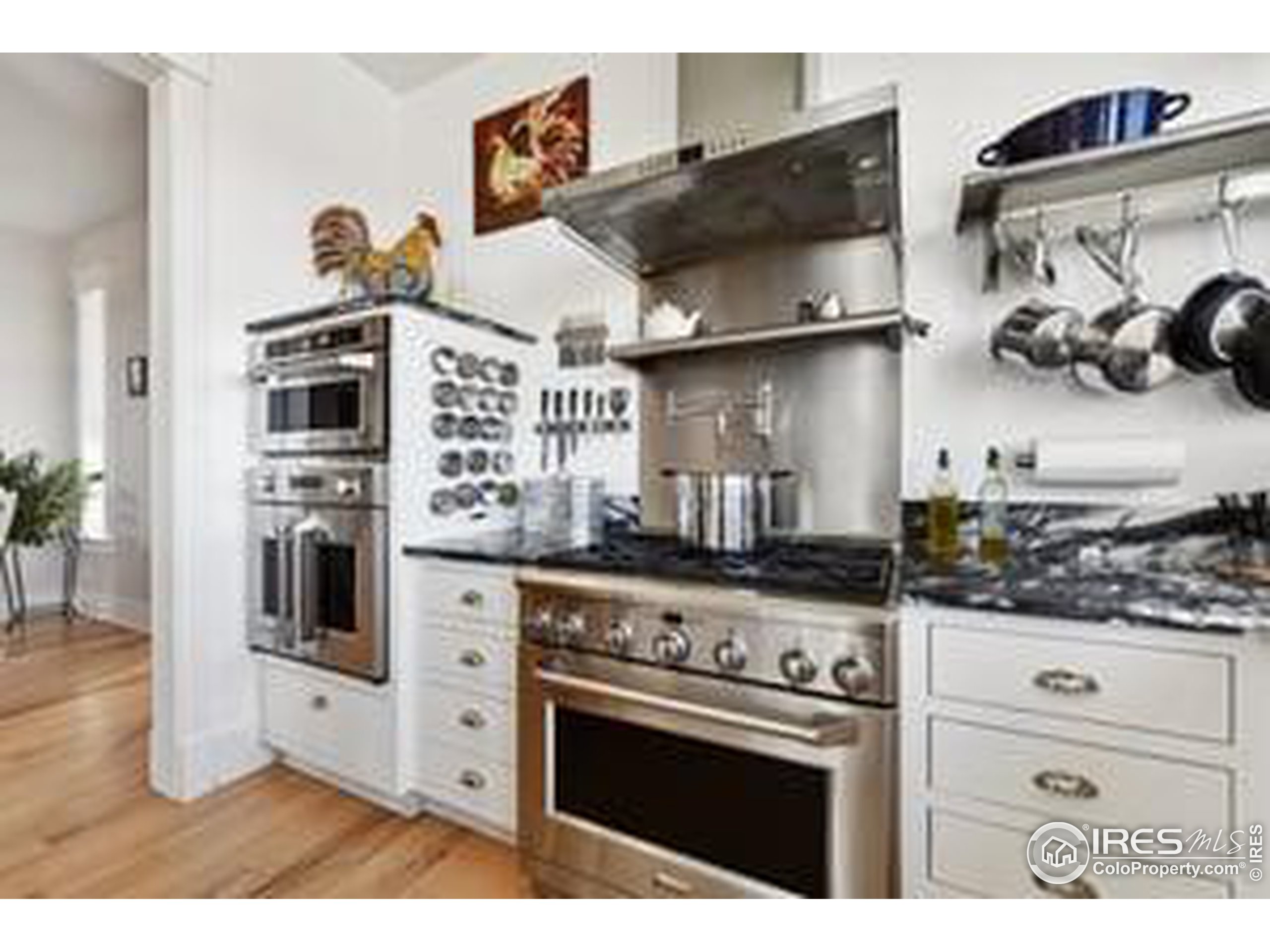 6261 County Road 41 Fort Lupton, CO 80621 - Photo 9 of 40 a kitchen with stainless steel appliances a stove and cabinets
