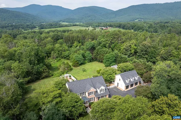 an aerial view of a house with a yard
