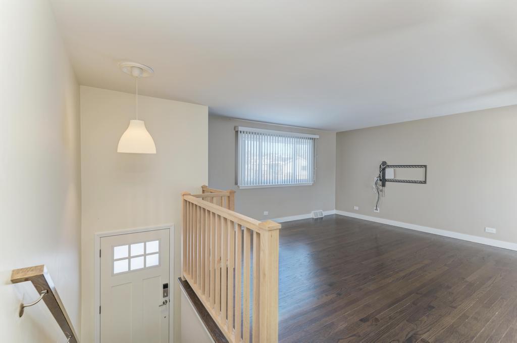89 South Highview Avenue Addison, IL 60101 - Photo 3 of 25 a view of an empty room with wooden floor and a window