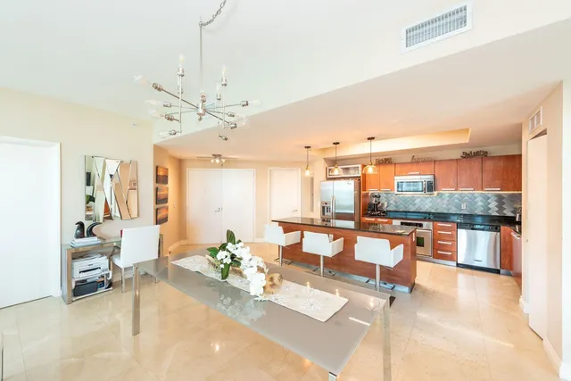 a living room with stainless steel appliances kitchen island granite countertop furniture and a kitchen view