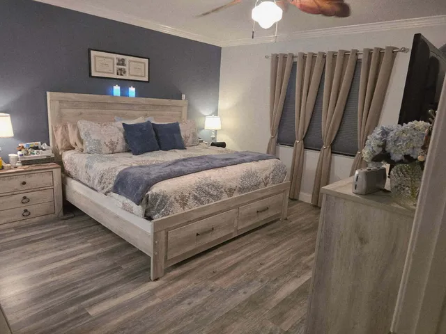 a bedroom with a bed and flat screen tv