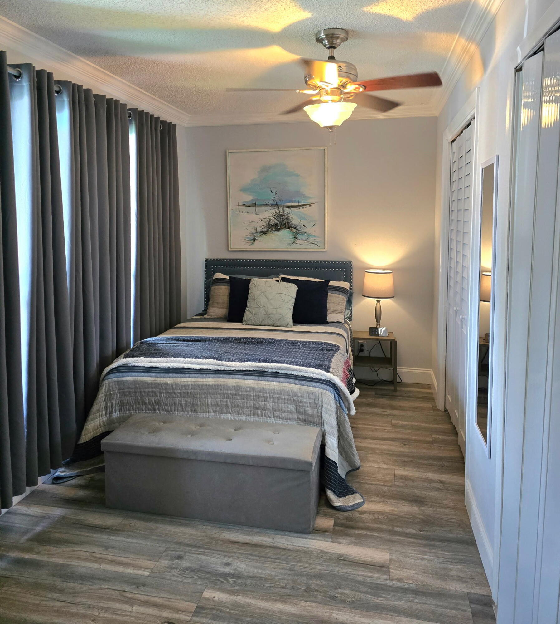 2720 Southwest 15th Street, Unit 2C Delray Beach, FL 33445 - Photo 20 of 31 a bedroom with a bed and a chandelier