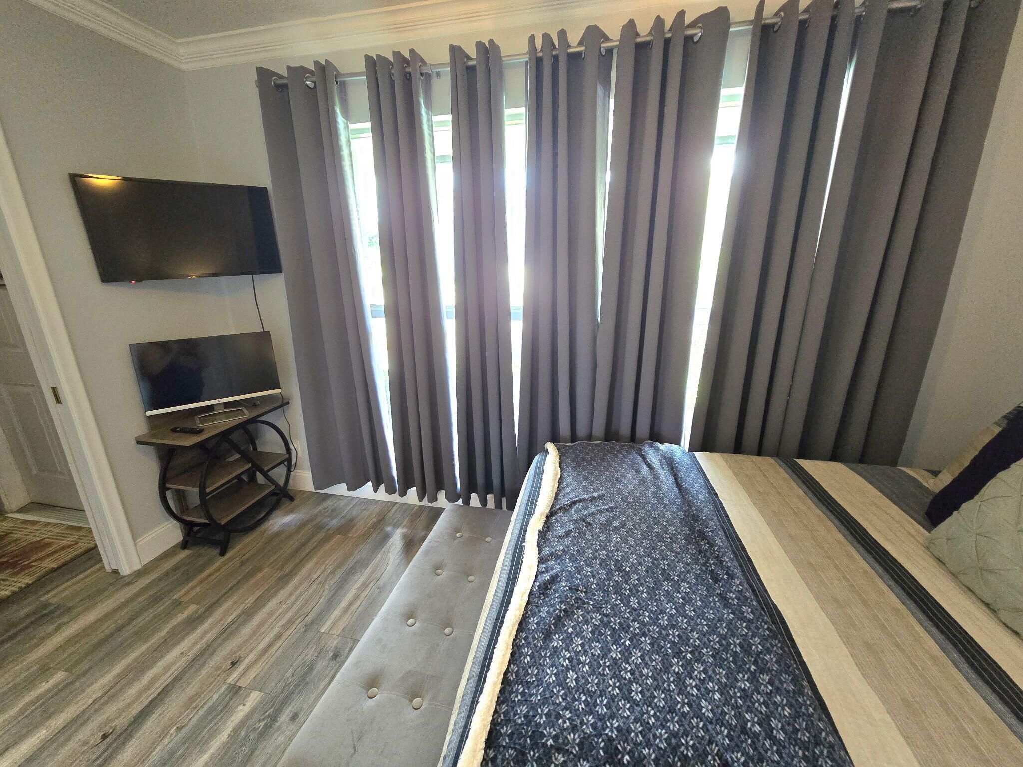 2720 Southwest 15th Street, Unit 2C Delray Beach, FL 33445 - Photo 21 of 31 a bedroom with a bed and a television