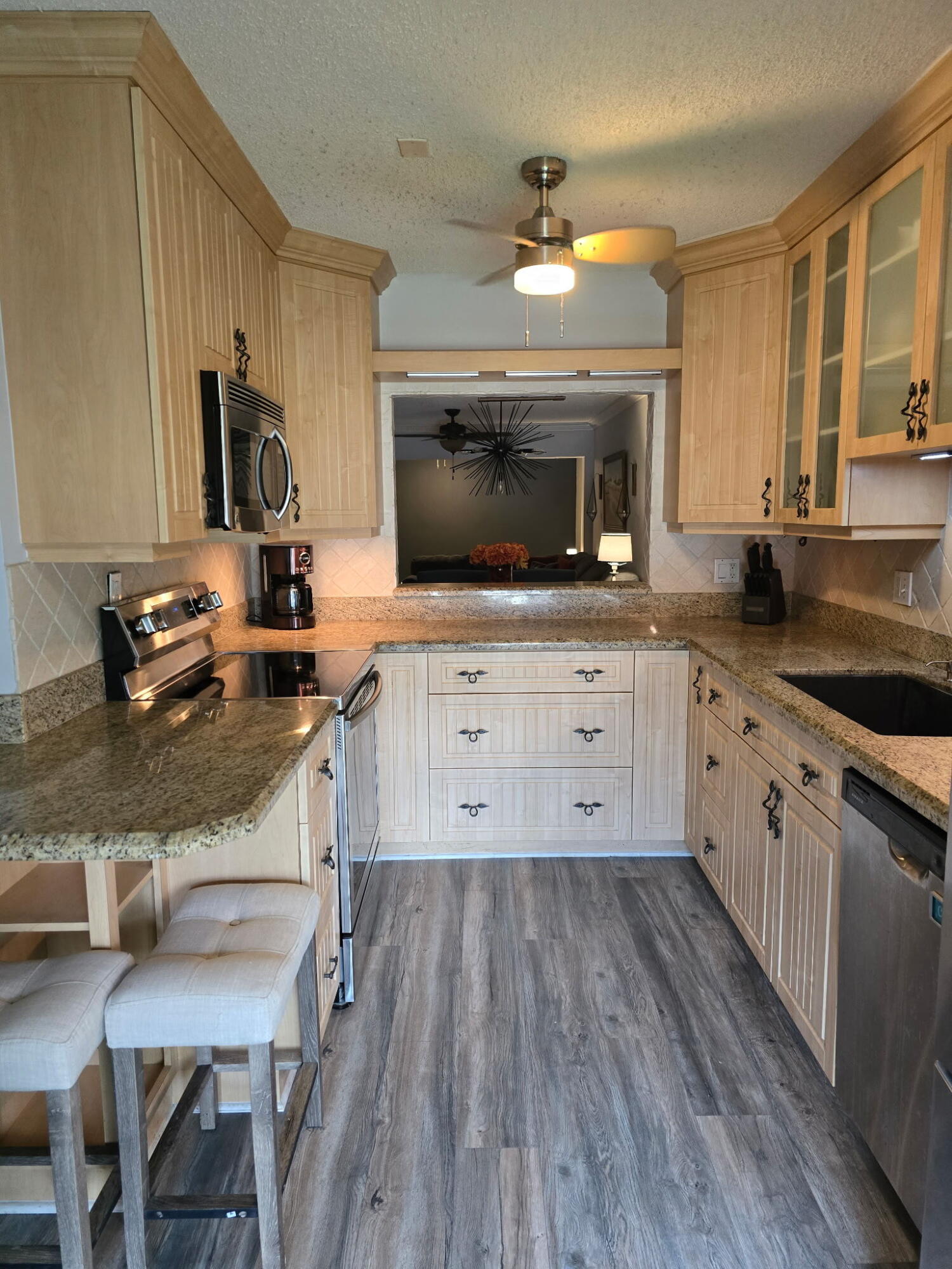 2720 Southwest 15th Street, Unit 2C Delray Beach, FL 33445 - Photo 3 of 31 a kitchen with a sink stove and microwave