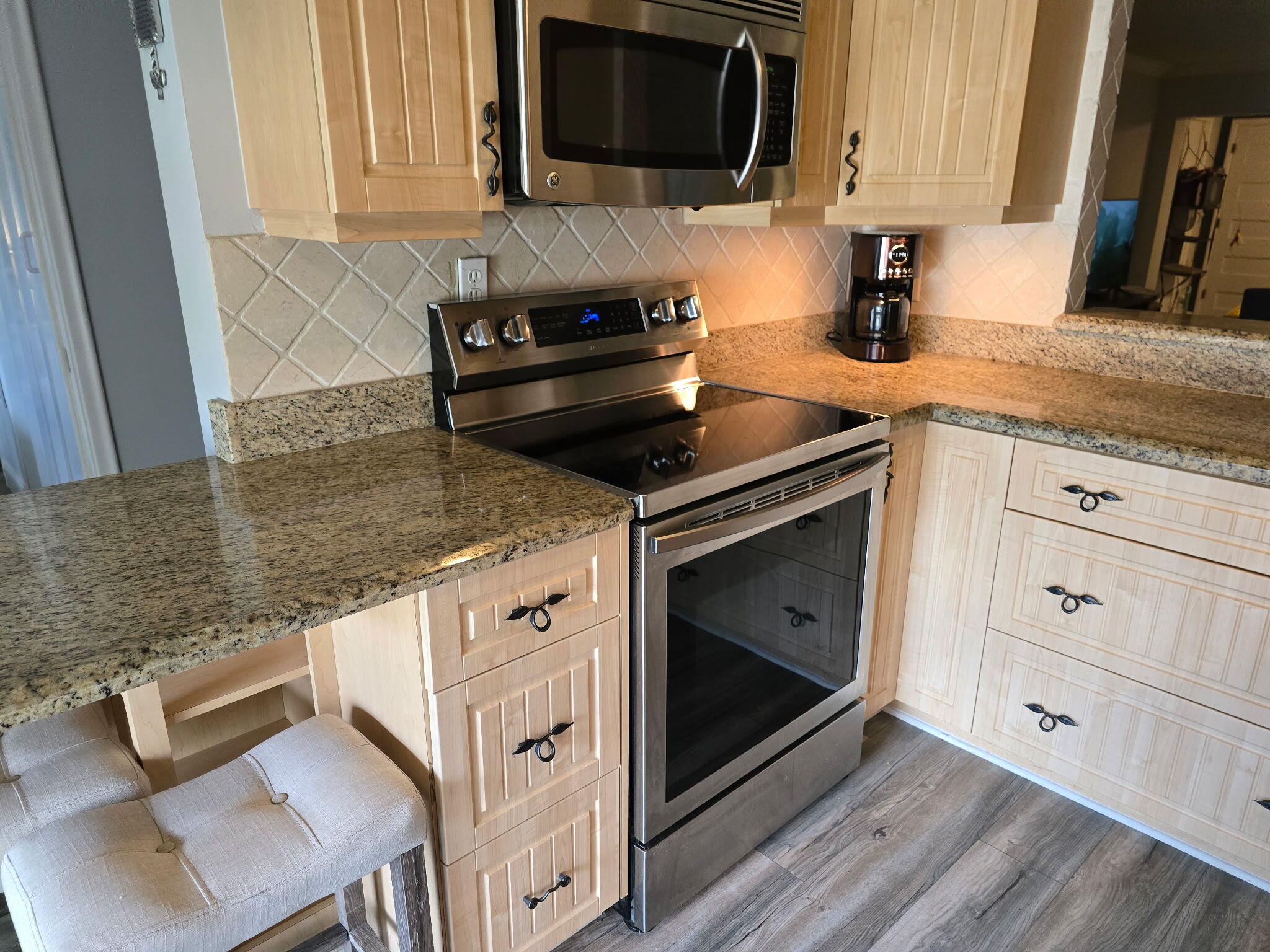 2720 Southwest 15th Street, Unit 2C Delray Beach, FL 33445 - Photo 4 of 31 a kitchen with granite countertop a stove and a sink