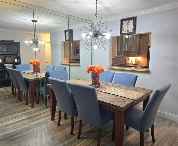 a dining room with furniture a chandelier and window