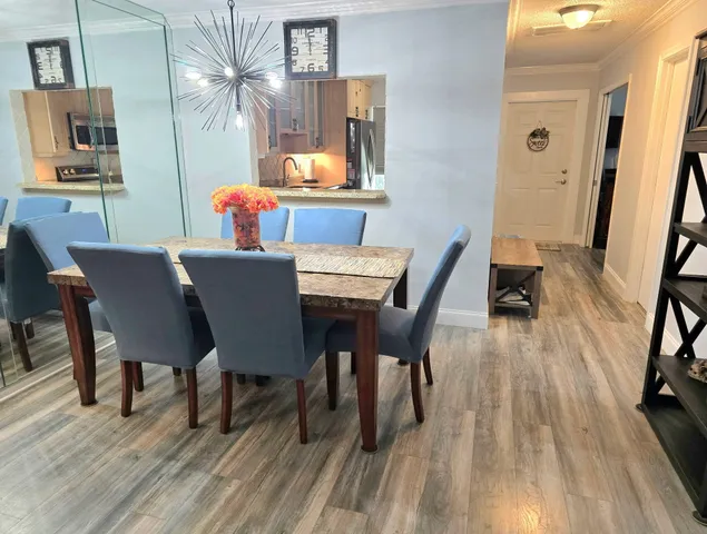 a dining room with furniture and wooden floor
