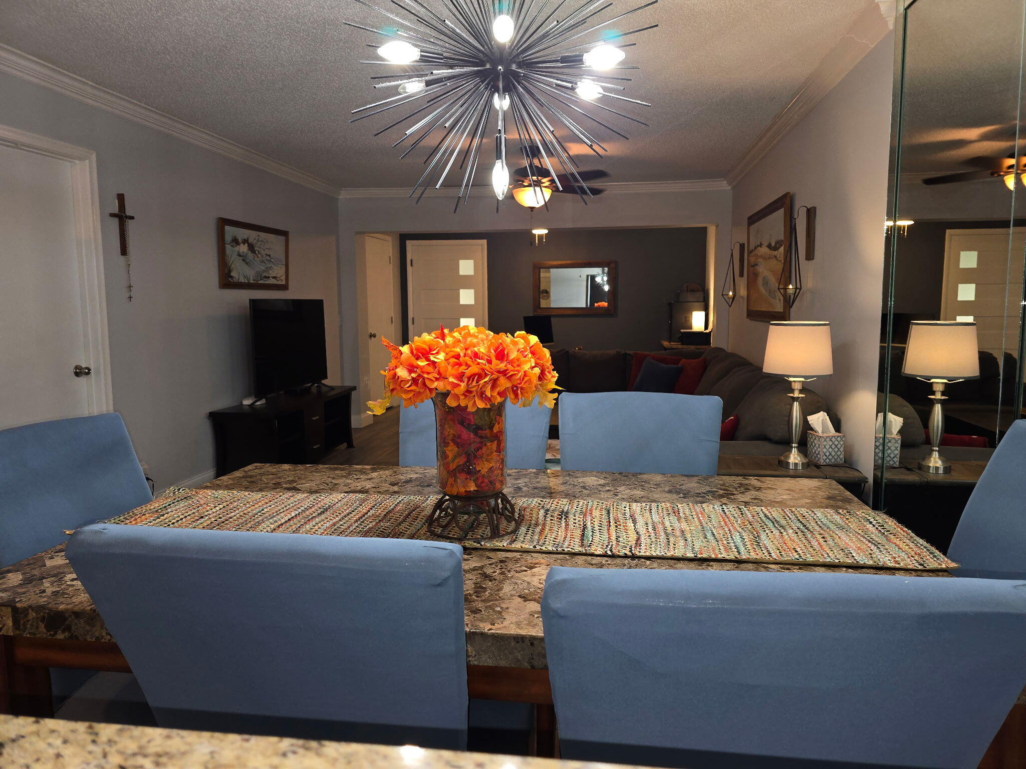 2720 Southwest 15th Street, Unit 2C Delray Beach, FL 33445 - Photo 10 of 31 a living room with furniture and a chandelier