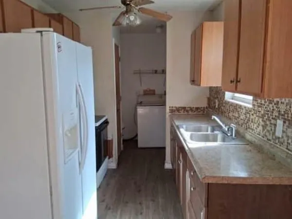 a kitchen with a refrigerator sink and stove