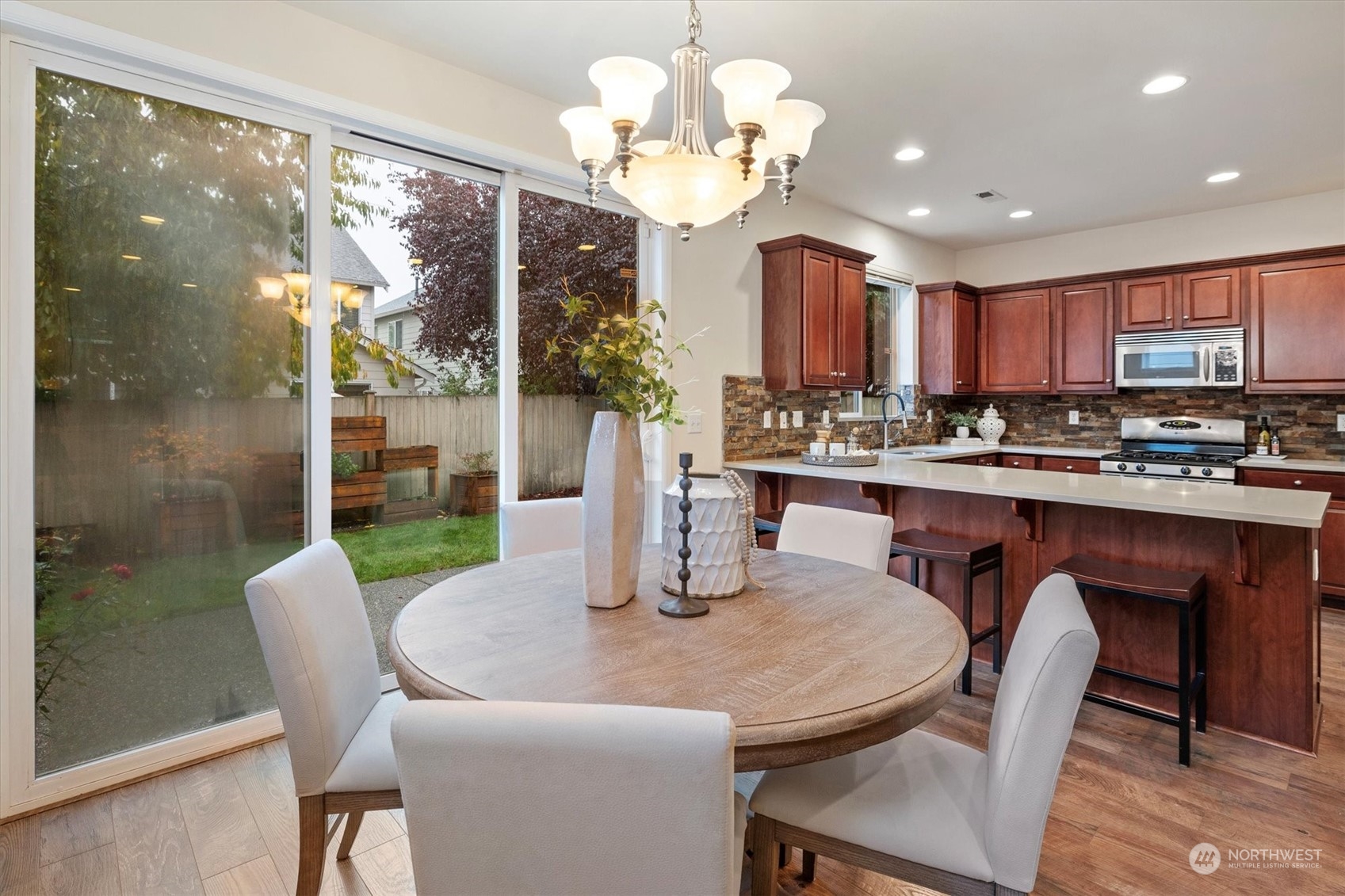 16023 35th Park Southeast Bothell, WA 98012 - Photo 14 of 34 a kitchen with a dining table chairs and a chandelier