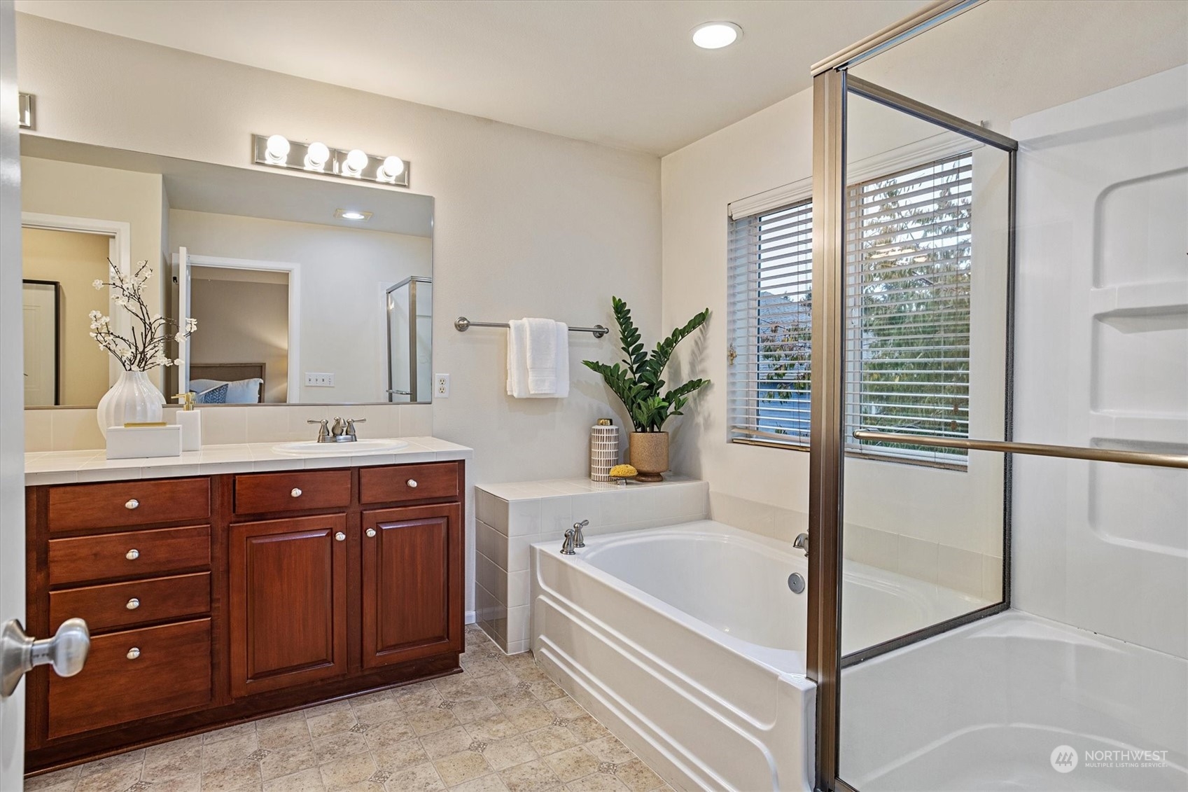 16023 35th Park Southeast Bothell, WA 98012 - Photo 19 of 34 a bathroom with a tub a double vanity sink and a large mirror