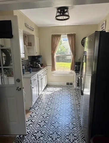 a kitchen with a refrigerator and a stove