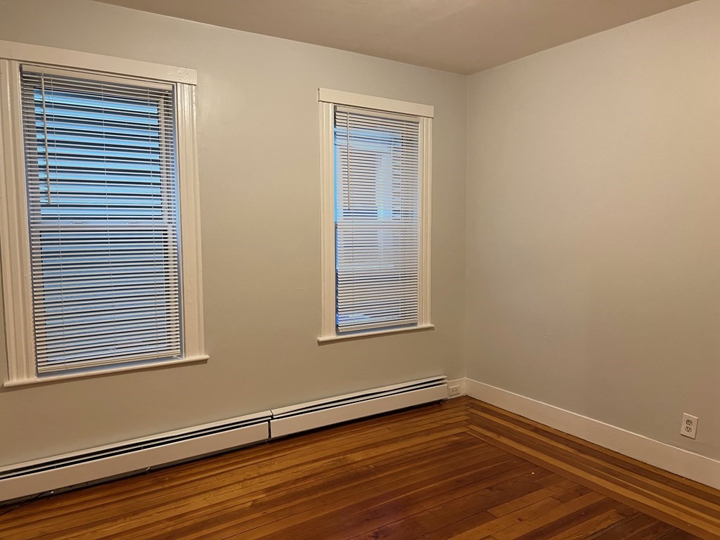 3 Carson Street, Unit 1 Boston, MA 02125 - Photo 6 of 14 a view of an empty room with wooden floor and a window