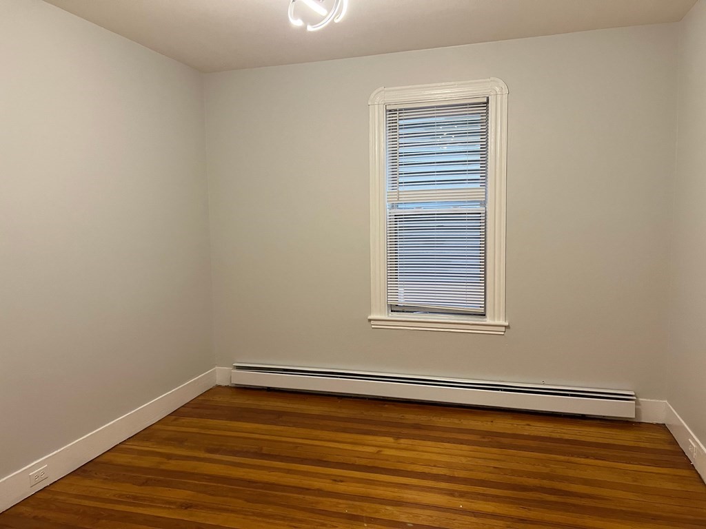 3 Carson Street, Unit 1 Boston, MA 02125 - Photo 8 of 14 a view of a room with wooden floor and a window