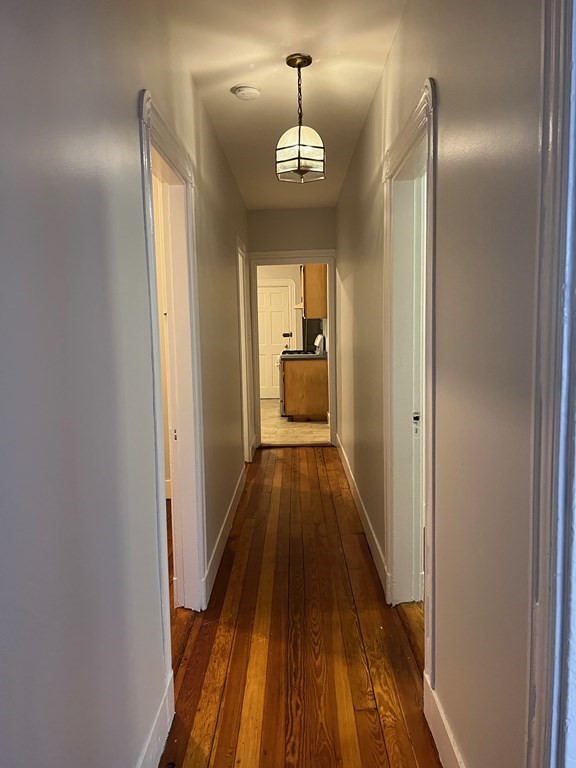 3 Carson Street, Unit 1 Boston, MA 02125 - Photo 9 of 14 a view of a hallway with wooden floor and staircase