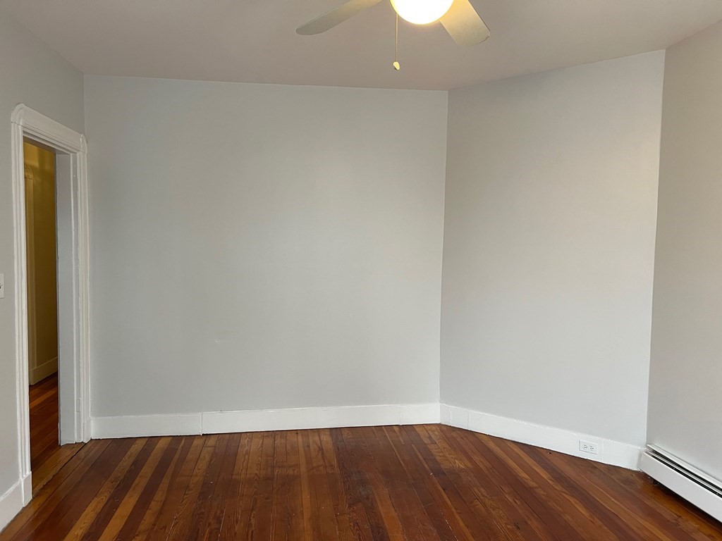 3 Carson Street, Unit 1 Boston, MA 02125 - Photo 10 of 14 a view of an empty room with wooden floor and a window