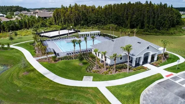 a front view of residential houses with yard and green space