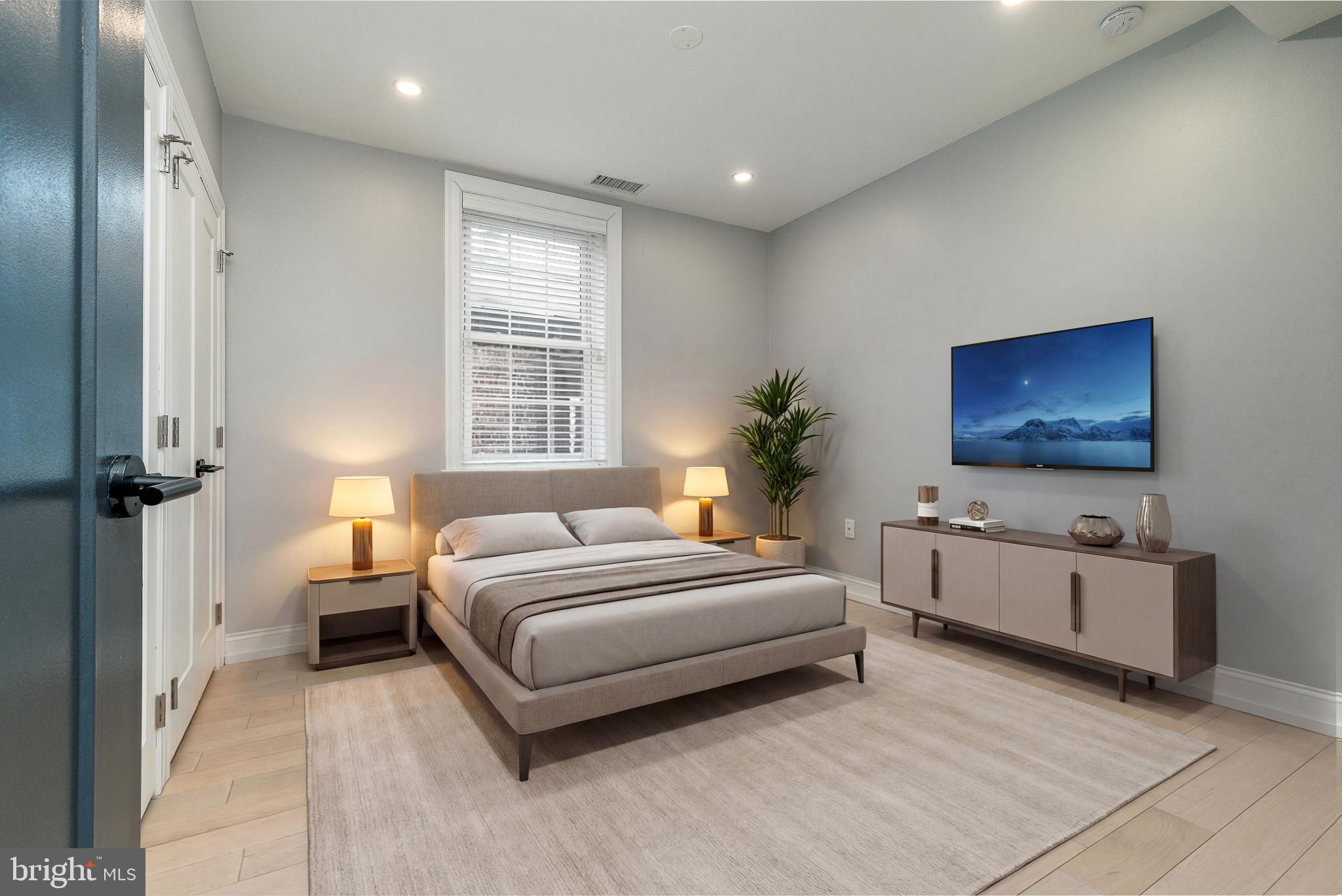 908 Spruce Street, Unit 10 Philadelphia, PA 19107 - Photo 11 of 41 a spacious bedroom with a large bed and a flat screen tv